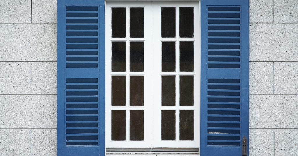 Blue plantation shutter with a white window
